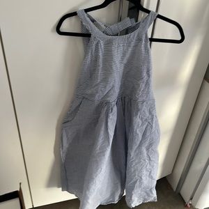 Nom maternity dress blue white striped with pockets and cut out in back.